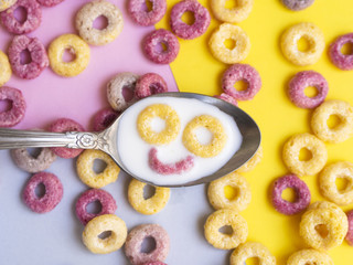 Close-up spoon with cereal smiley face