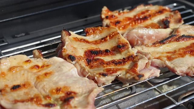 Pieces of chicken meat grilling on barbecue grill. Preparing testy chicken drumstick on grill