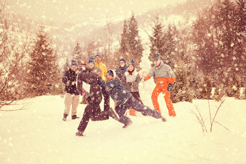 group of young people having fun in beautiful winter landscape
