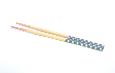 wooden chopstick with blue-white ornament in white background