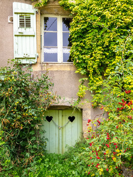 Architectural detail of an old neglected overgrown building in the village of Avioth, France