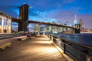 Brooklyn bridge at night with Manhattan in the background , New York