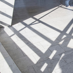 Dark smooth lines of shadows in a light marble interior