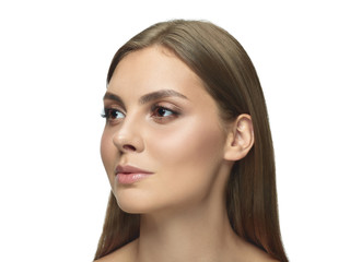 Fototapeta premium Portrait of beautiful young woman isolated on white studio background. Caucasian female model looking at side and posing. Concept of women's health and beauty, self-care, body and skin care.