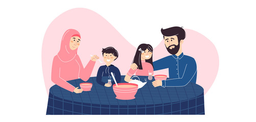 Happy Muslim family enjoying their meal together. Mother in hijab, a father and their son and daughter eating traditional food with tea. Islamic family holiday dinner and spending time at home.