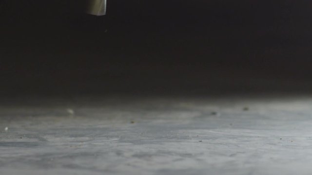 Shooting.The cartridge from the gun falls to the ground.Reload the gun. Slow motion