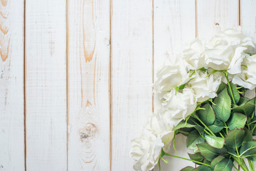 Top view of wedding flowers on white wood background