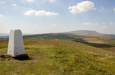Trig point on Weets Hill with Pendle Hill in background