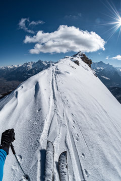 Subjective view on winter crest, splitboarder climbs to the top, alps, Aosta Valley, Italy