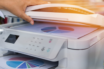 Business office Concept : Hand person employed open press button on panel of printer for process...