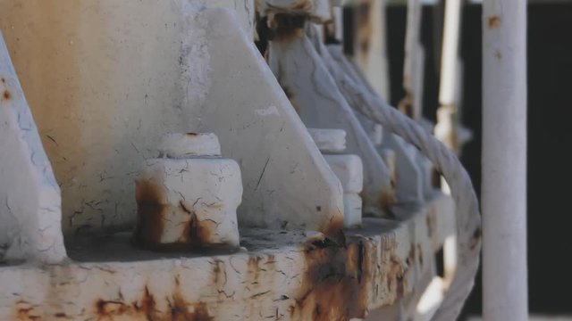 old white rusty pipe of large ship above calm blue wavy water surface close view. Harbor, port
