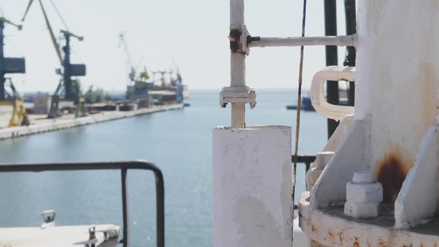 old white rusty pipe of large ship above calm blue wavy water surface close view. Harbor, port
