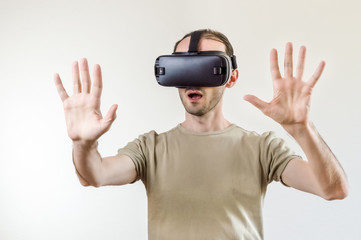 Man exploring modern technology virtual reality with head mounted display on white background