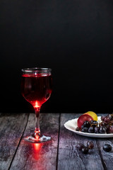 Pink wine. Wine in a glass near fruits and grapes. Traditional Georgian wine according to ancient technology. Copy space Close up and vertical orientation.