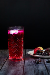 Barberry lemonade, ice drink. Enriched with vitamins. On a dark background