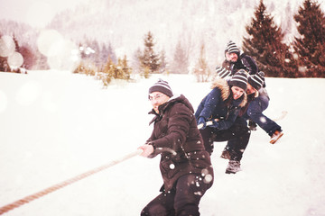 group of young people pulling a rope in tug of war competition