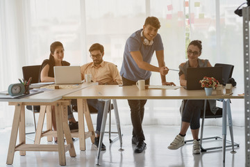 Working through some concepts. Two modern young men conducting a business presentation while standing in the board room