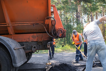 Road repair by a team of professional builders
