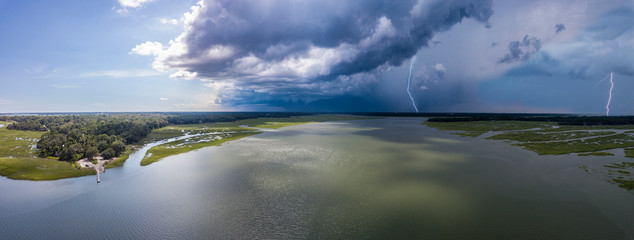 Aerial view of summer thunderstorm with lightning bolts over coastal South Carolina.