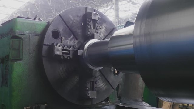 Big roll are created on the metal rolling machine at the plant. Creation of profiles, machine for creation of rolls from steel sheet. Rolling mill preparation workshop. Machining of machine parts.