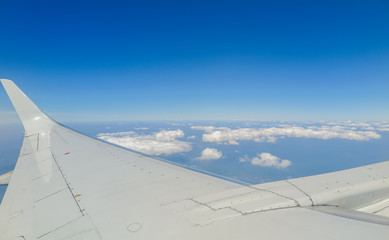 View from the plane to the clouds and sea