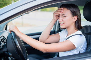 Fototapeta na wymiar Sad woman driver in car feeling negative emotion