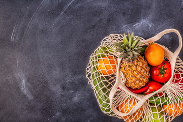 Fresh vegetables and fruits in bag mesh.