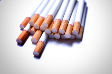 Asian cigarettes place the stack together on a white background red cigarette butt smoking and causing lung cancer