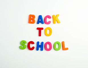 inscription back to school from multi-colored plastic letters