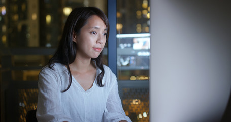 Woman working over night on computer