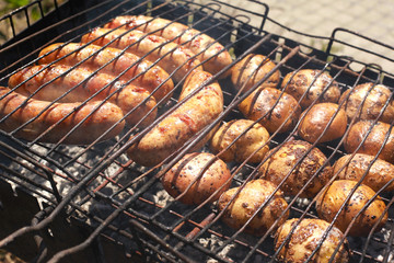 charcoal grilled pork sausages with baked potatoes