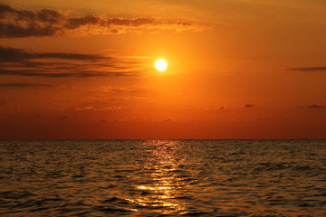 Beautiful sunset at the sea. The sea in the foreground. Background