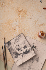 Artist's workspace flatlay. Art equipment on rustic background. Overhead image with copy space.