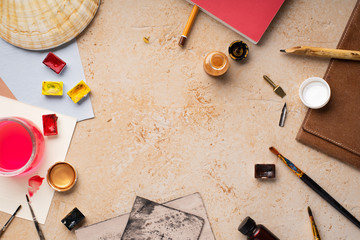 Artist's workspace flatlay. Art equipment on rustic background. View from above with copy space.