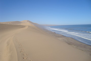 Fototapeta na wymiar Where the Desert meets the Sea. Photograph of Sandwich Harbour, South of Walvis Bay, Namibia.