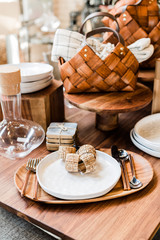 modern table setting, silver ware, wooden tray, woven bamboo ring