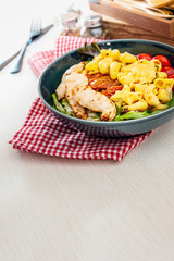 close-up of plate of pasta and chicken with lettuce