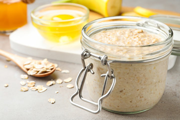 Handmade face mask and ingredients on light marble table, closeup
