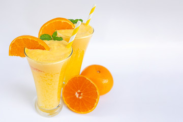 Orange smoothies Morning drinks on a healthy summer vacation on a wooden or white background.
