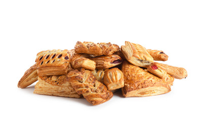 Heap of fresh tasty puff pastries on white background