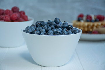 Fresh blueberries on a light background.