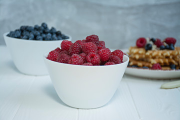 Fresh raspberries on a light background.