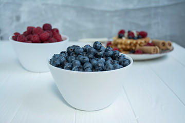 Fresh blueberries on a light background.