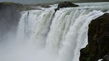 Godafoss, Iceland: Godafoss majestic waterfall against cloudy sky. A spectacular Icelandic waterfall in the North country.