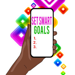Writing note showing Set Smart Goals. Business concept for giving criteria to guide in the setting of objectives Closeup of Smartphone Device Held in Hand and Text Space