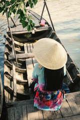Woman sitting on the wooden boat