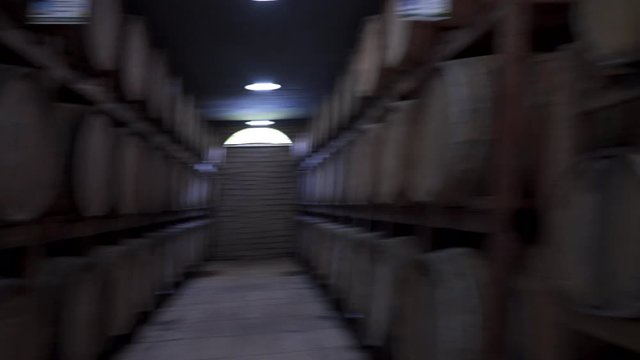 shot back in a corridor between wooden barrels with liquor
