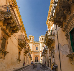 Panoramic view of a street of the baroque old town of Noto in Sicily, Italy.