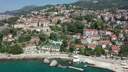 Flight over the blue sea towards a seashore