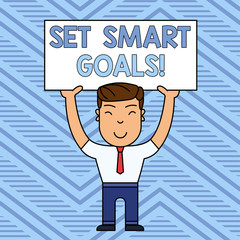 Word writing text Set Smart Goals. Business photo showcasing list to clarify your ideas focus efforts use time wisely Smiling Man Standing Holding Big Empty Placard Overhead with Both Hands